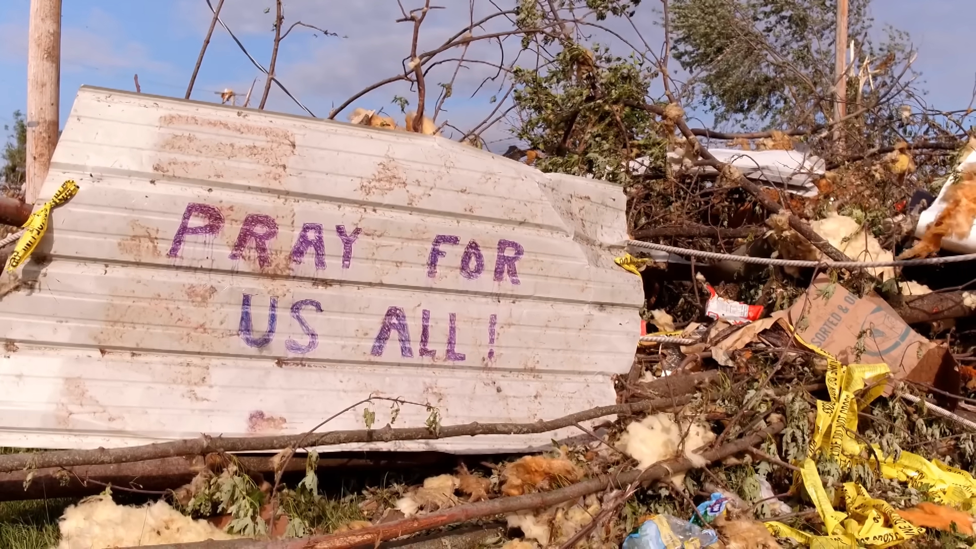 Ohio neighbourhood with plank that says "Pray for us all"